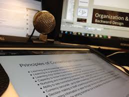 Microphone and script displayed on a screen