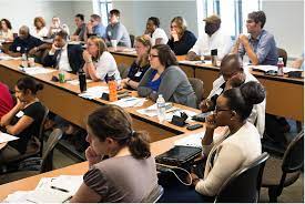 Students in a classroom seated at long tables